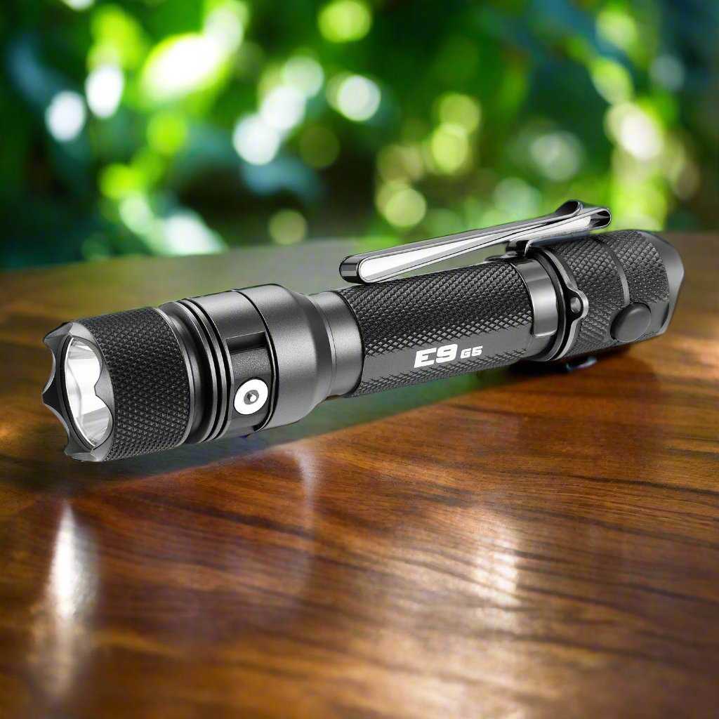 Powertac E9 Gen5 EDC rechargeable tactical flashlight on wooden surface