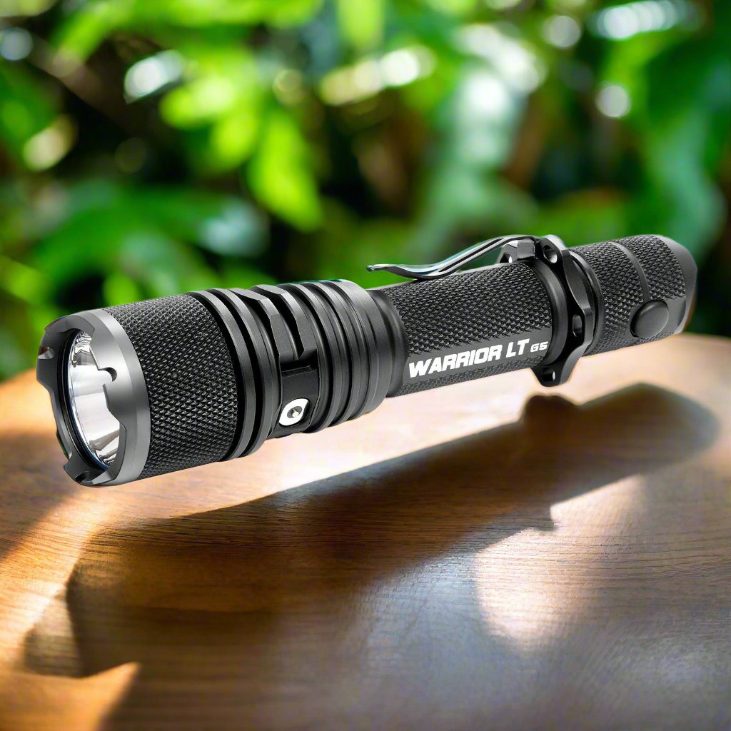 Powertac Warrior Gen5 LT tactical flashlight on wooden surface – Lumex Flashlights authorized dealer for Powertac and COAST