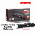 A PowerMac M5 Gen3 flashlight shown in front of its retail box on a white background, with text overlays reading '2030 LUMENS' and 'Everything You Need To Light Up The Darkness.' The product is black with a silver textured grip and white logo, and the box is dark gray/black with red and white text.